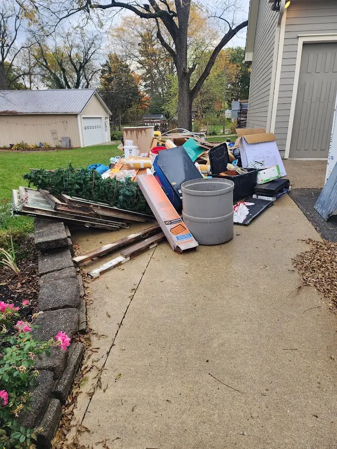 Dumpster being loaded with debris for Roofing Dumpster Rental in White Plains